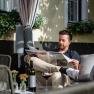 Guest garden at the Edelmann winery & guest room, man reading the newspaper