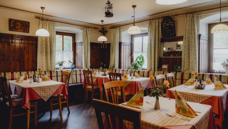 Cozy inn with wooden furniture and checkered tablecloths.