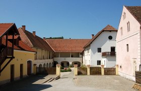 Inner courtyard of the Dominikalhof Bromberg with historic buildings and red tiled roofs.