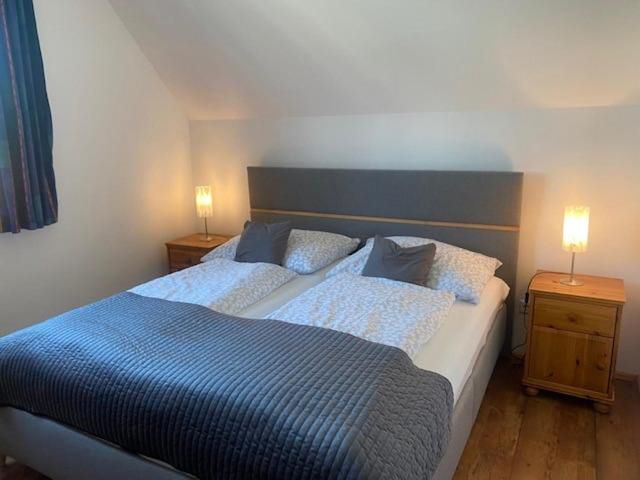 Comfortable bedroom with double bed, two bedside tables and lamps.