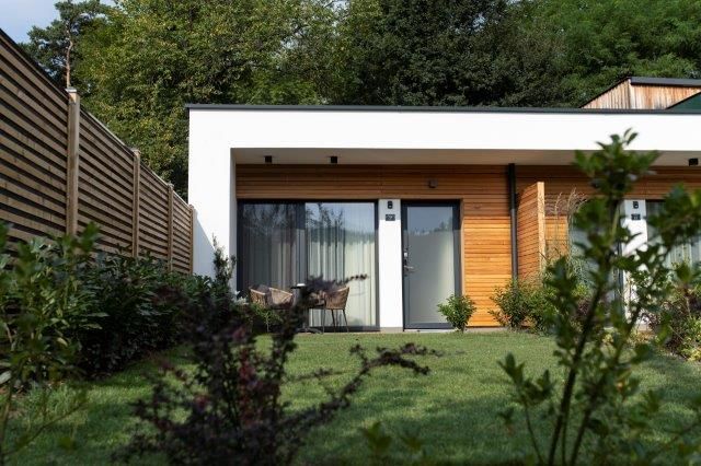 Modern guest house with wood paneling and garden.