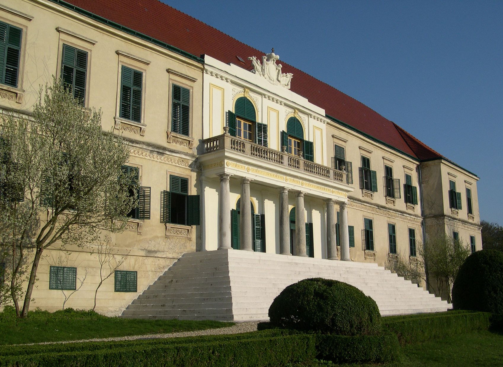 Loosdorf Castle with wide staircase and green shutters.