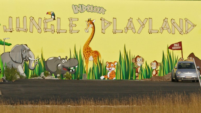 Mural with jungle animals and 'Jungle Playland' lettering.