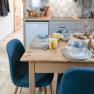 Breakfast table in a modern kitchen with blue and white bowls and yellow cups.