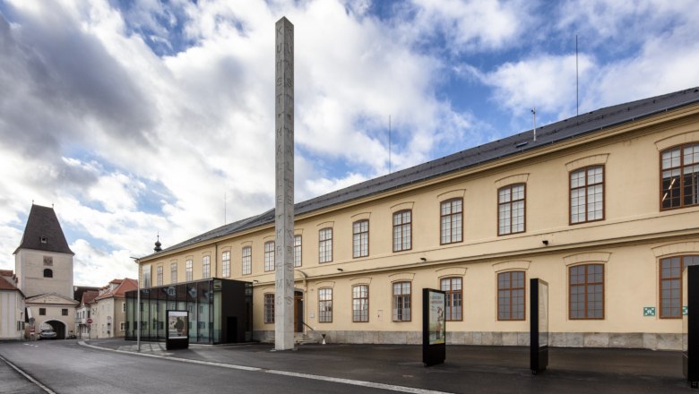 Exterior view of the Kunsthalle Krems with modern glass entrance and historic building.