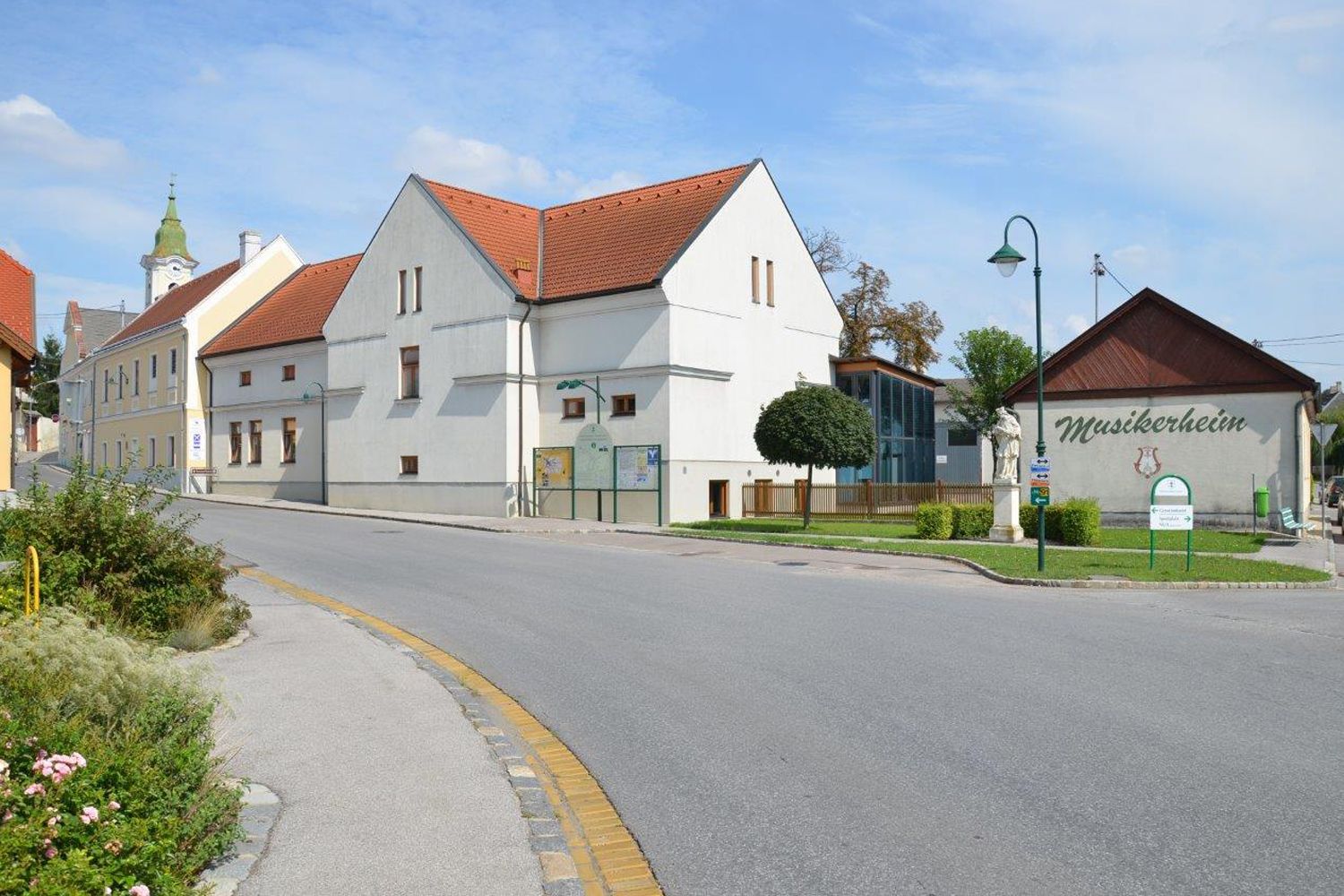 Street scene in Hohenruppersdorf with musicians' home and church in the background.