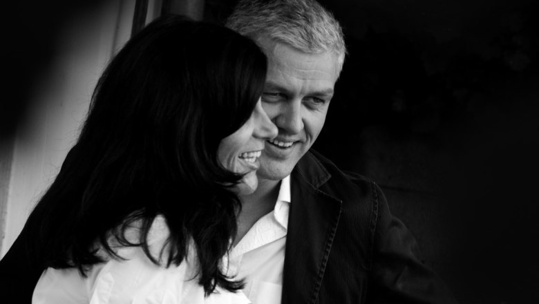 Black and white photo of a smiling couple close to each other.