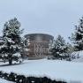 Snow-covered Therme Linsberg Asia with snow-covered trees in the foreground.
