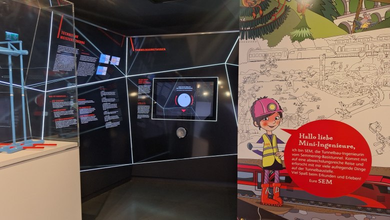 Exhibition about the Semmering Base Tunnel with information boards and children's illustrations.