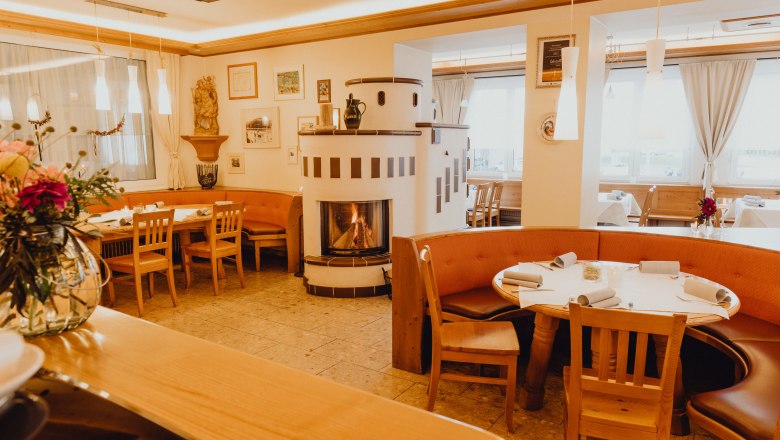 Cozy restaurant with fireplace and wooden furniture in the Vienna Alps.