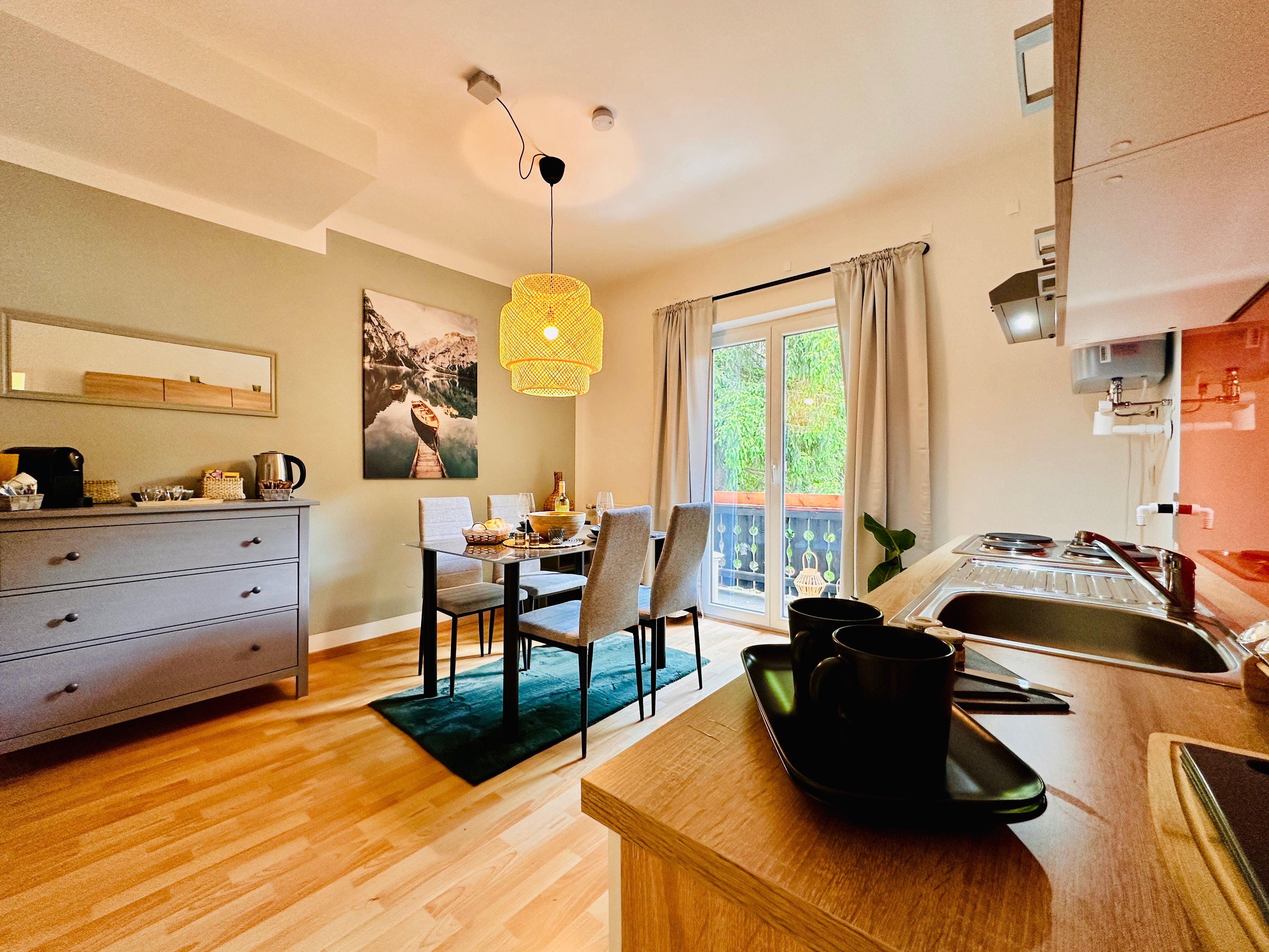 Cozy apartment with dining table, kitchenette and balcony.