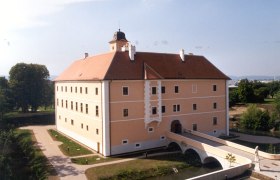 V&ouml;sendorf Castle with bridge and gardens.