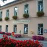 Facade of the Hotel Wegscheidhof with flower boxes and signs.