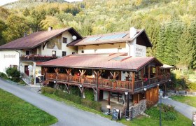Aerial view of the Forellenhof in a wooded area.
