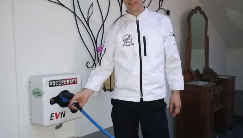 Roman Siebenhandl stands next to the e-charging stations