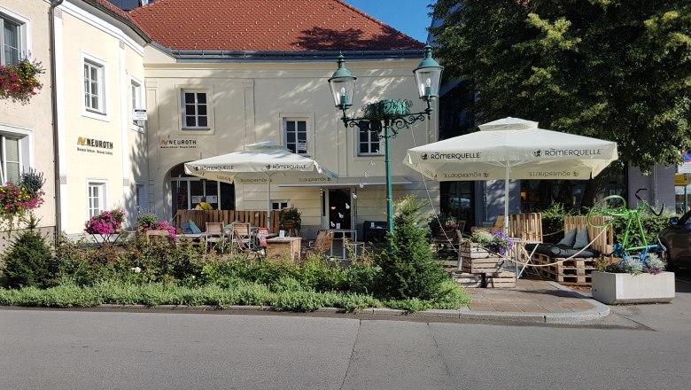Café from outside, yellow facade 2 sunshades
