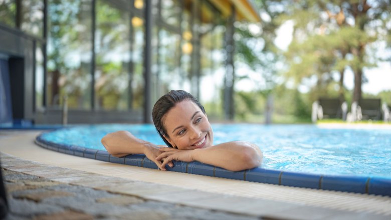 Woman relaxing in the pool at the edge.