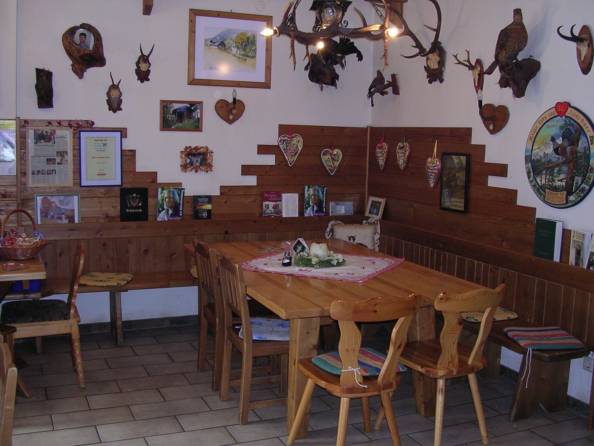 Cozy parlor with wooden furniture and hunting trophies on the walls.