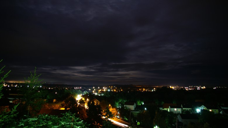 Night view of Ennsdorf with illuminated houses and dark sky.