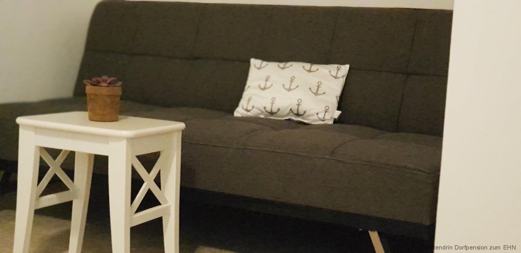 Gray sofa with white table.