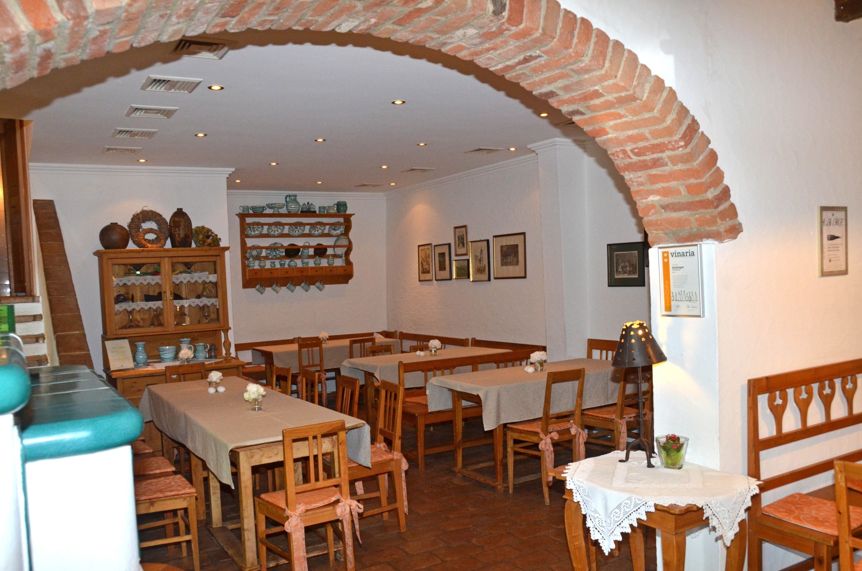 Cozy interior of a wine tavern with wooden furniture and decorations.