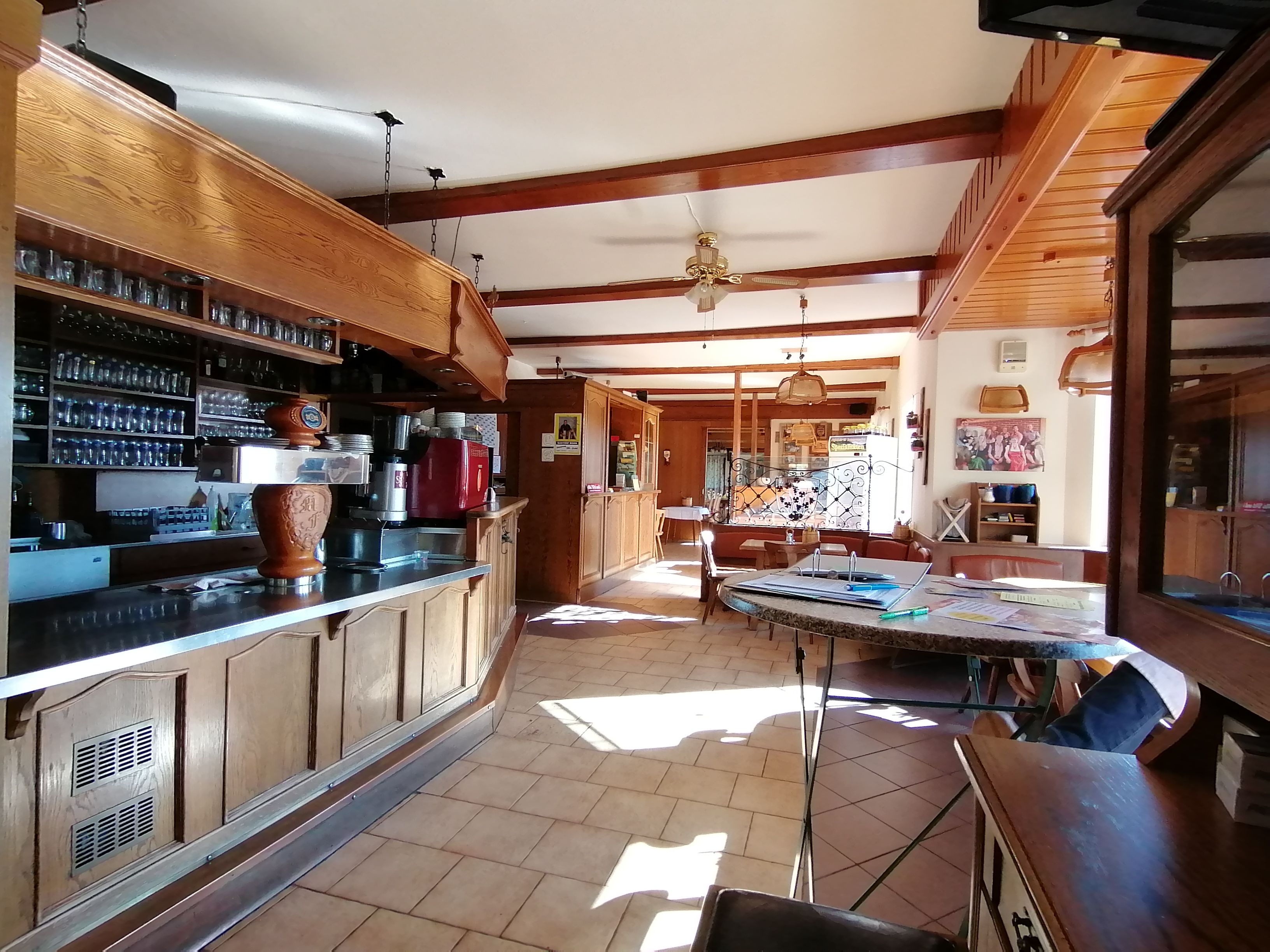 Interior view of a traditional restaurant with wooden furniture and bar.