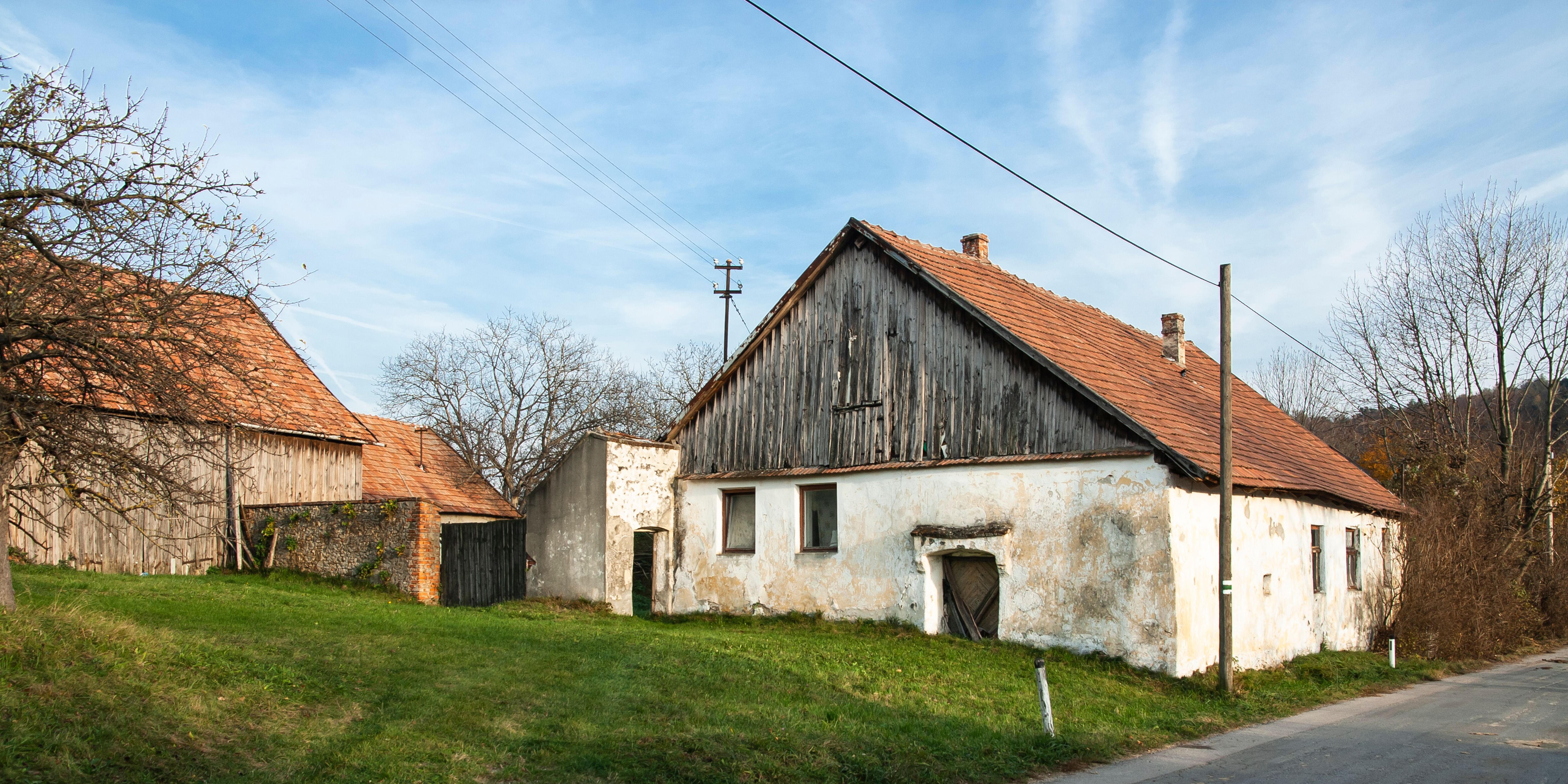 Old buildings in the Sieghartskirchen wine cellar lane with red tiled roofs and weathered facades.