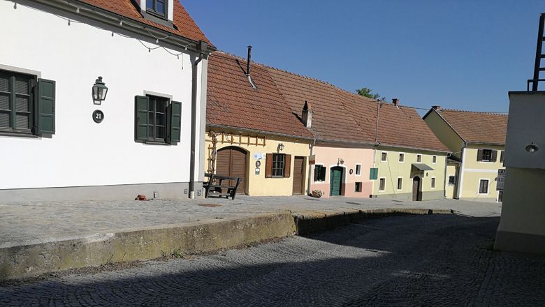 Colorful houses in the Rohrendorf wine cellar lane in sunny weather.