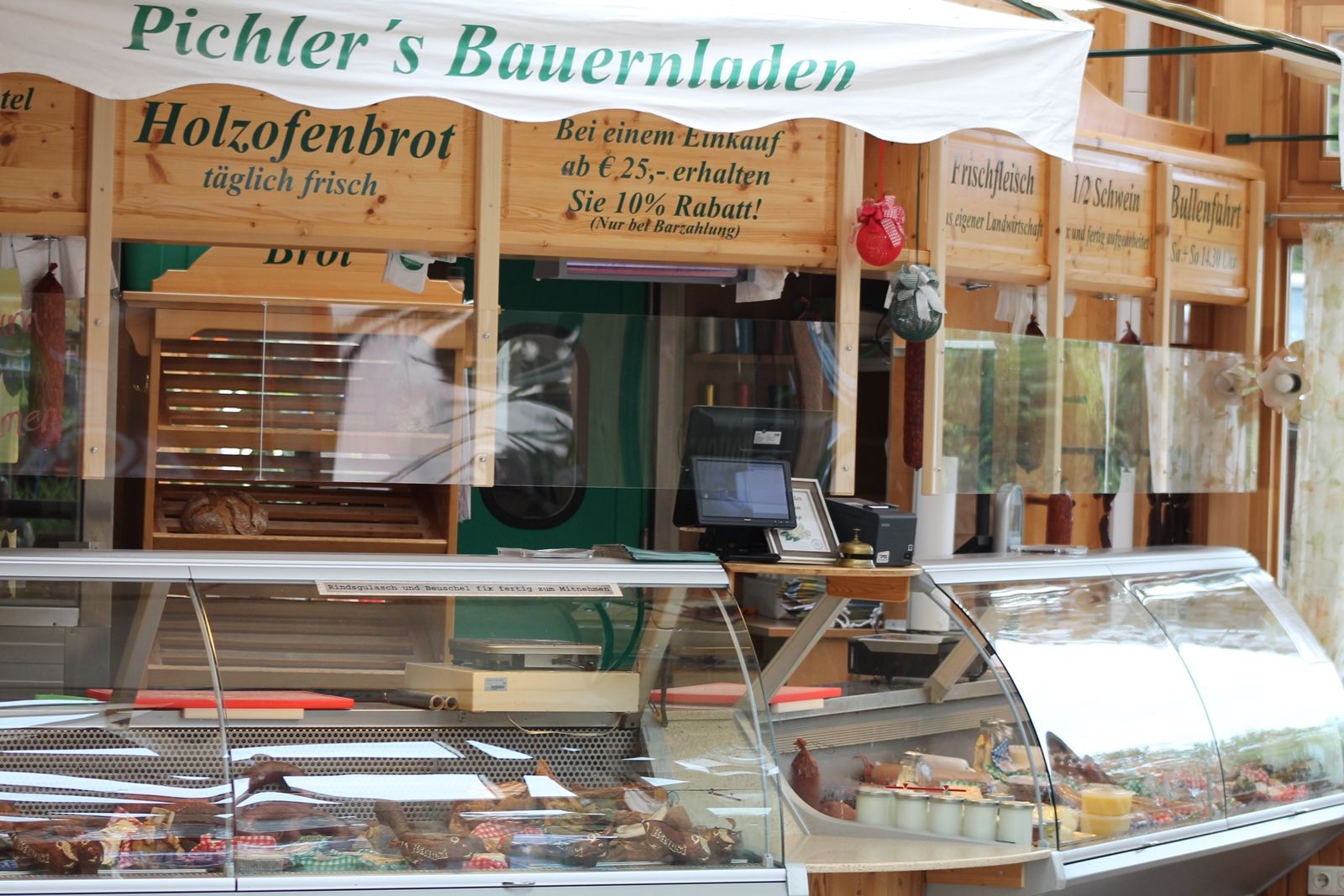 Interior view of a farm store with counter and wood-fired bread.