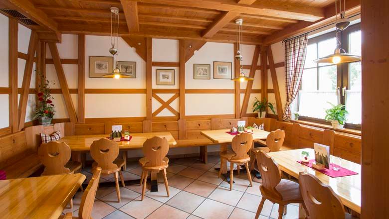 Interior view of a traditional wine tavern with wooden furniture and decoration.
