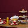 Breakfast table with coffee, orange juice, bread rolls and tray with egg and cold cuts.