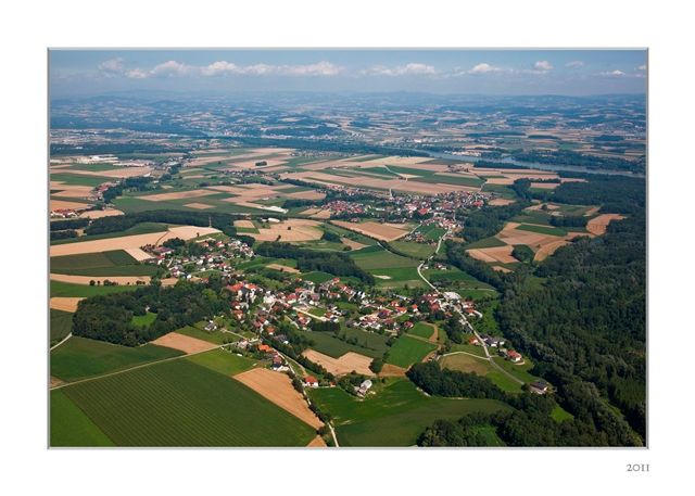 Aerial view of St. Pantaleon-Erla with fields and forests.