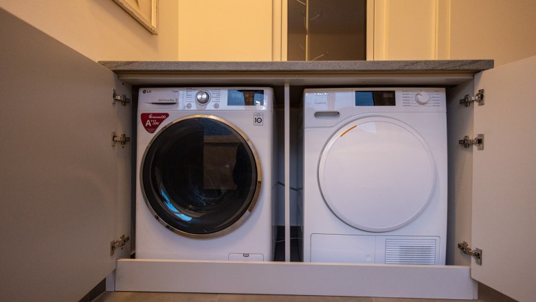 Washing machine and dryer built into a cupboard.
