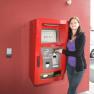 Woman uses check-in machine at the Cleverhotel Herzogenburg.