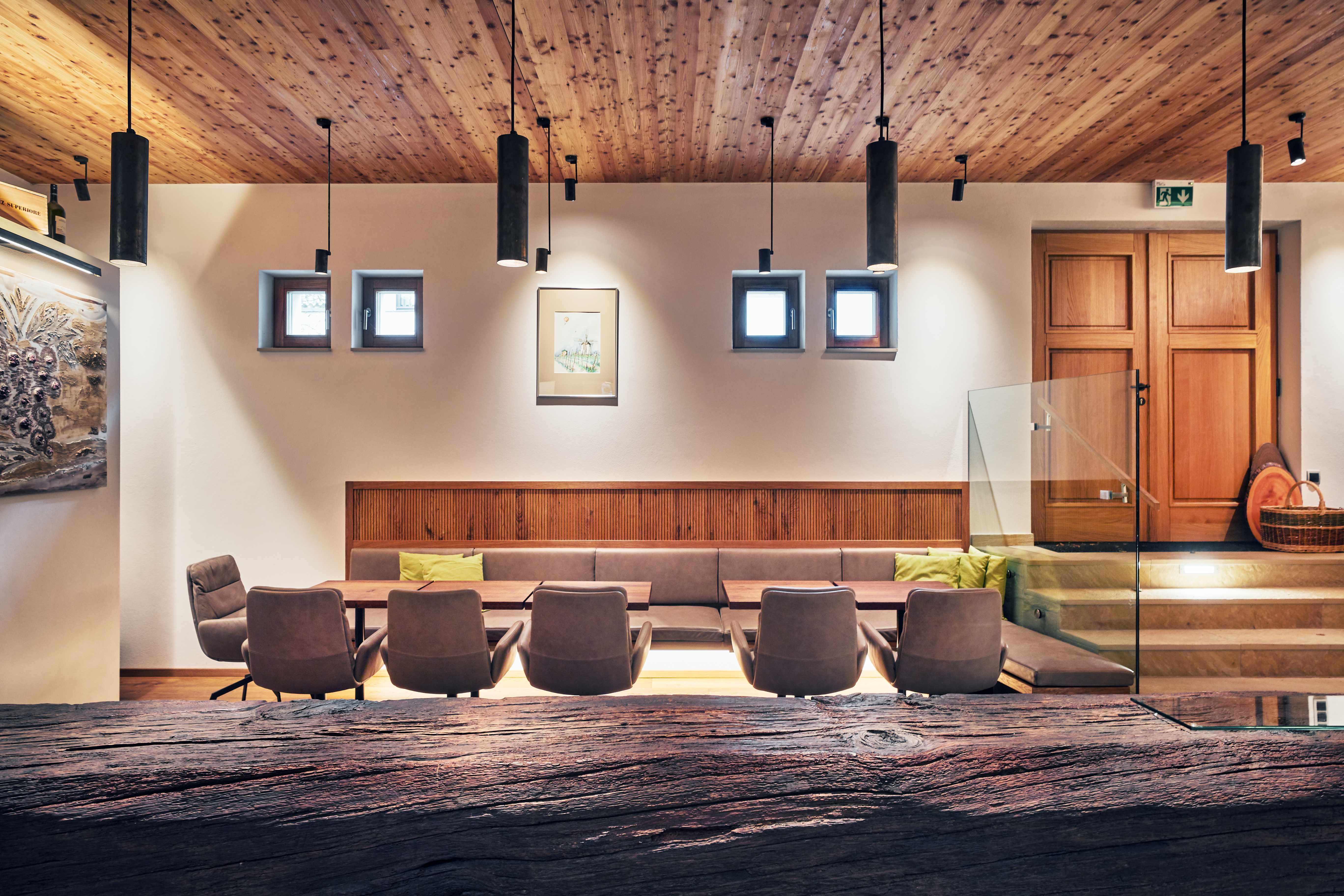 Modern interior with wooden elements, seating area and decorative lamps.