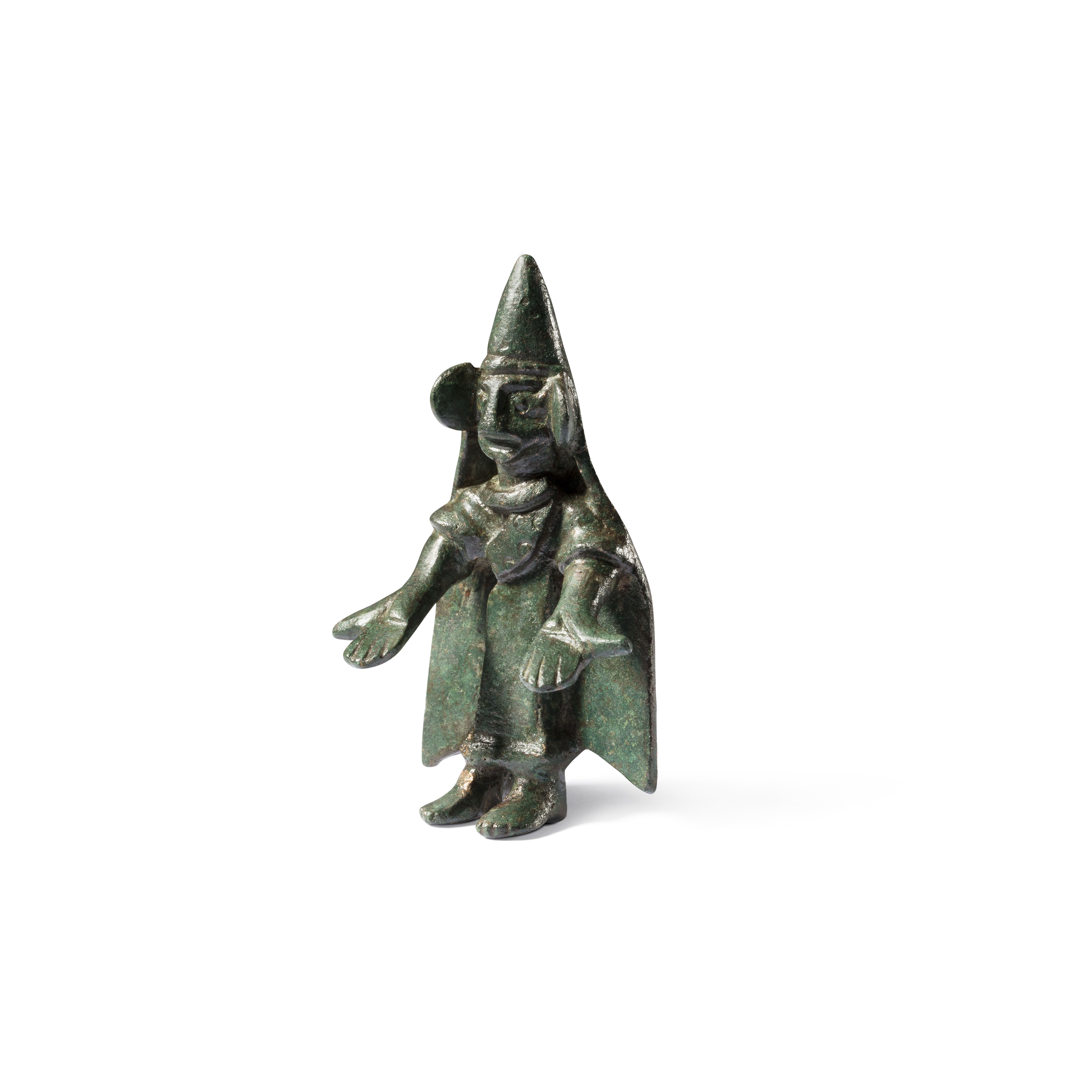 Bronze statuette of a praying figure with pointed hat and outstretched arms.