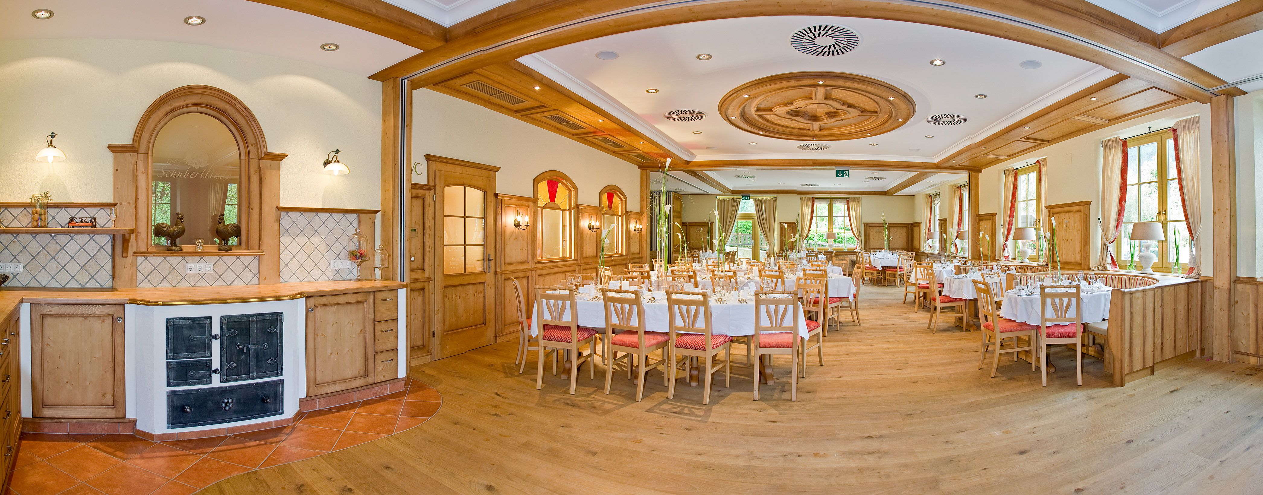 Elegant, wood-paneled dining room with set tables and large windows.