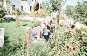 Family looking at flowers in the garden.