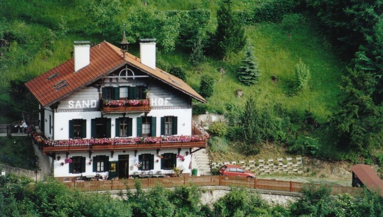 Traditional house called Sand-Hof in a green landscape.