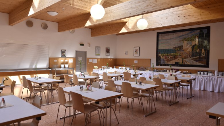 Breakfast room laid out with tables for a group
