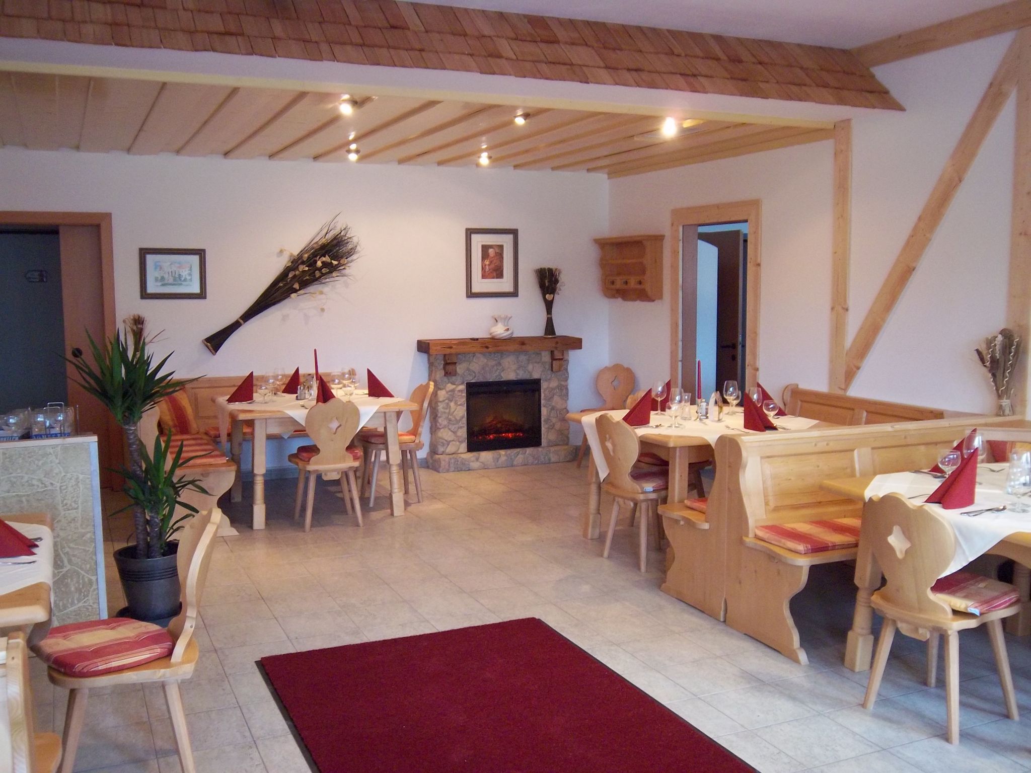 Cozy guest room with wooden furniture and fireplace.