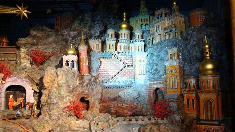 Detailed nativity scene landscape with buildings and figures.