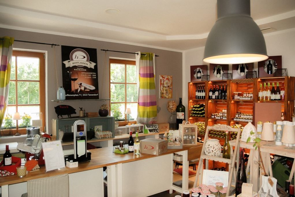Interior view of a farm store with shelves full of wine bottles and products.