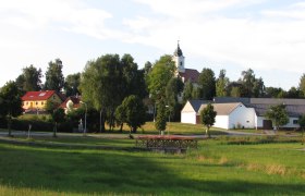 Rural scene with church and houses in Haugschlag.