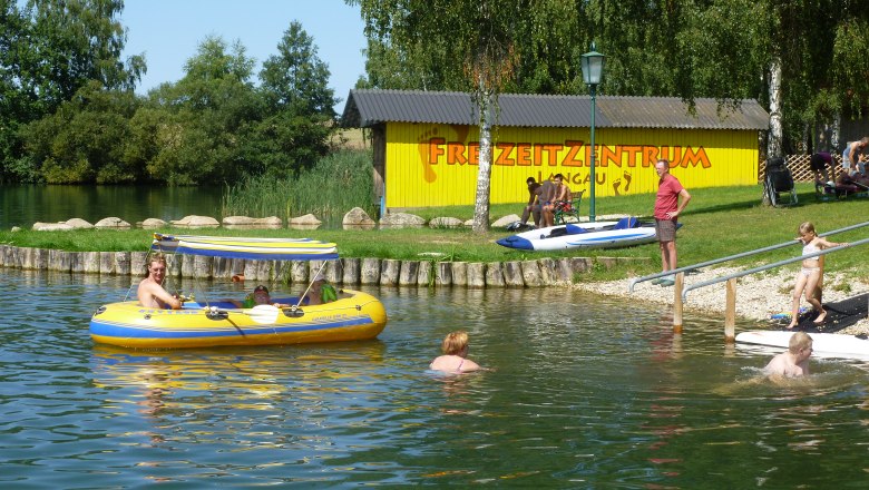 People enjoy a sunny day at the lake in the Langau leisure center.