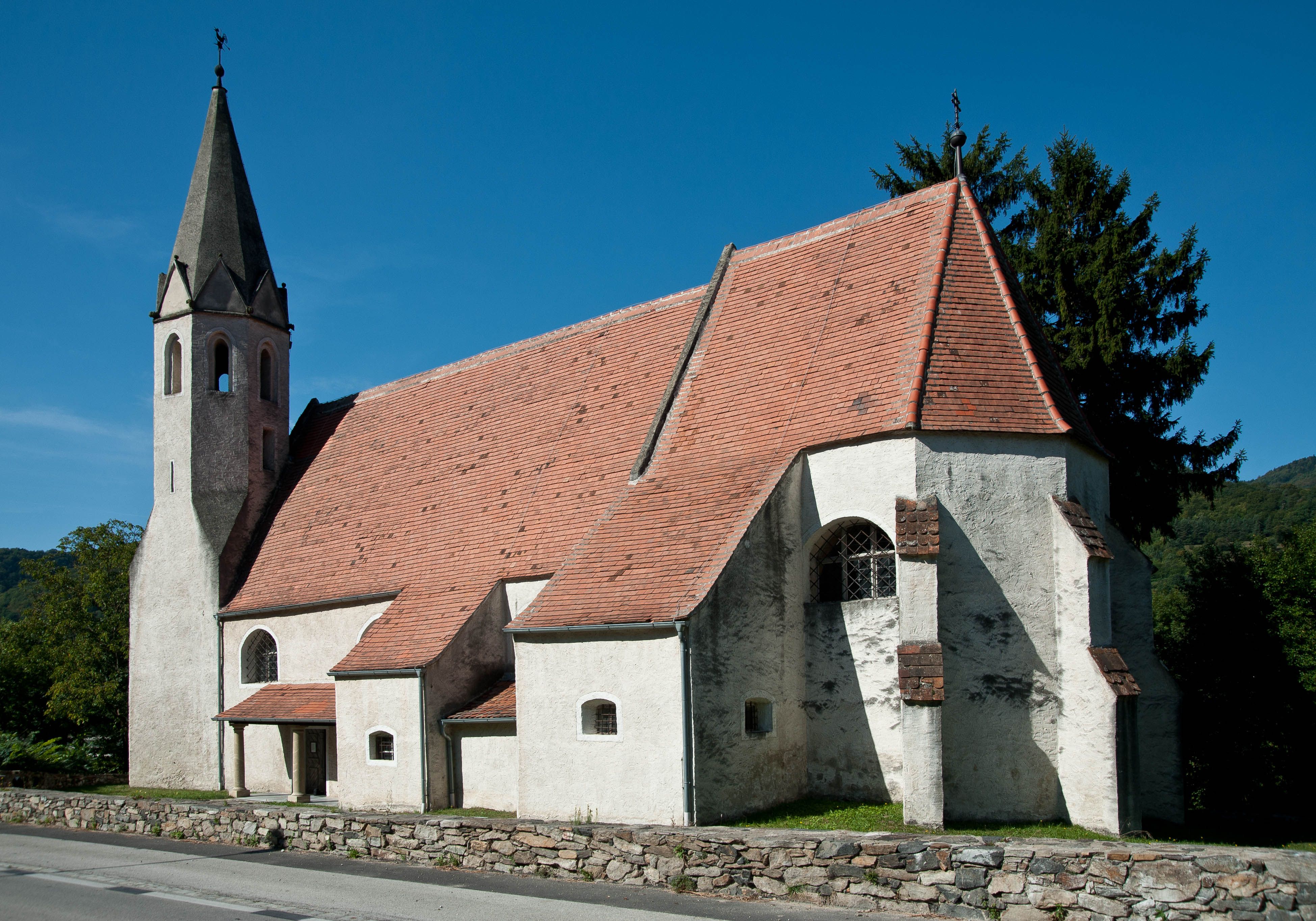 A branch church from the outside with a red roof