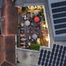 Aerial view of a winery with tables and parasols in the courtyard.