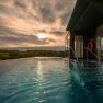 Infinity pool with a view of the landscape at sunset.