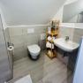 Bathroom with WC, washbasin and shower.