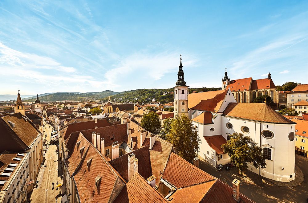 Panoramic view of the old town of Krems with churches and red roofs.